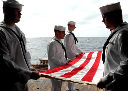 US Navy 081006-N-9134V-055 The burial detail folds the ceremonial flag in honor of a deceased Navy veteran during a burial at sea aboard the amphibious dock landing ship USS Carter Hall (LSD 50)
