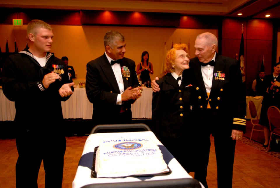 US Navy 081011-N-9818V-082 Master-At-Arms Seaman Jerry Ogg joins Master Chief Petty Officer of the Navy (MCPON) Joe R. Campa Jr., Senior Chief Rena Estes and Lt. Cmdr. Lew Katz to cut the Navy's birthday cake