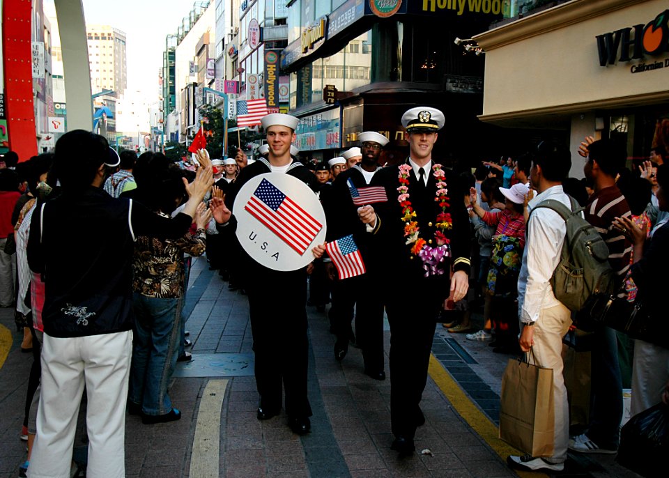 US Navy 081009-N-1062H-199 Sailors and officers from USS George Washington (CVN 73), USS Cowpens (CG 63) and USS John S. McCain (DDG 56) participate in the Busan Jagalchi Festival parade and wave to onlookers
