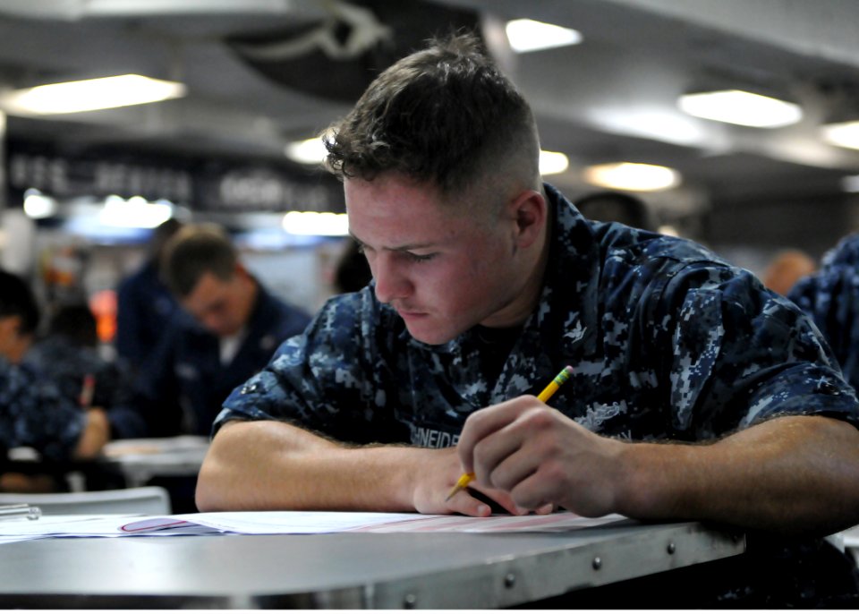 US Navy 100909-N-8113T-011 Operations Specialist 3rd Class Jonathan Schneider takes the Navy-wide E-5 advancement exam