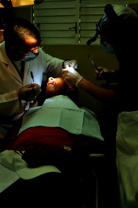 US Navy 081007-N-8907D-088 Cmdr. Michael Hill, embarked aboard the amphibious assault ship USS Kearsarge (LHD 3), and Dominican Republic Navy 1st Lt. Alexis Santana perform a tooth extraction