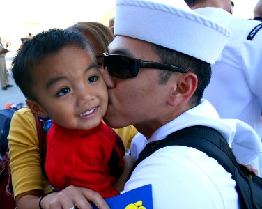 US Navy 081008-N-1328S-003 A Sailor assigned to Carrier Air Wing (CVW) 2 embarked aboard the aircraft carrier USS Abraham Lincoln (CVN 71) is embraced by his family photo