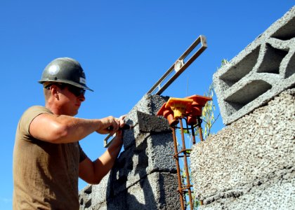 US Navy 081008-N-3560G-416 Builder 3rd Class Robert Russell constructs a block wall while building a bathroom facility photo