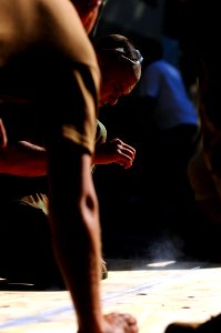 US Navy 081010-N-4515N-011 Air Force Airman 1st Class Ryan Moran snaps a chalk line on a sheet of plywood