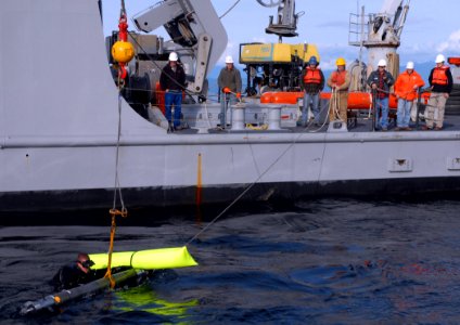 US Navy 081008-N-4021H-311 Navy Diver 2nd Class Jeremiah Ruddell harnesses an electronic counter-measure anti-torpedo for retrieval and return to Yard Tender Torpedo (YTT) 10