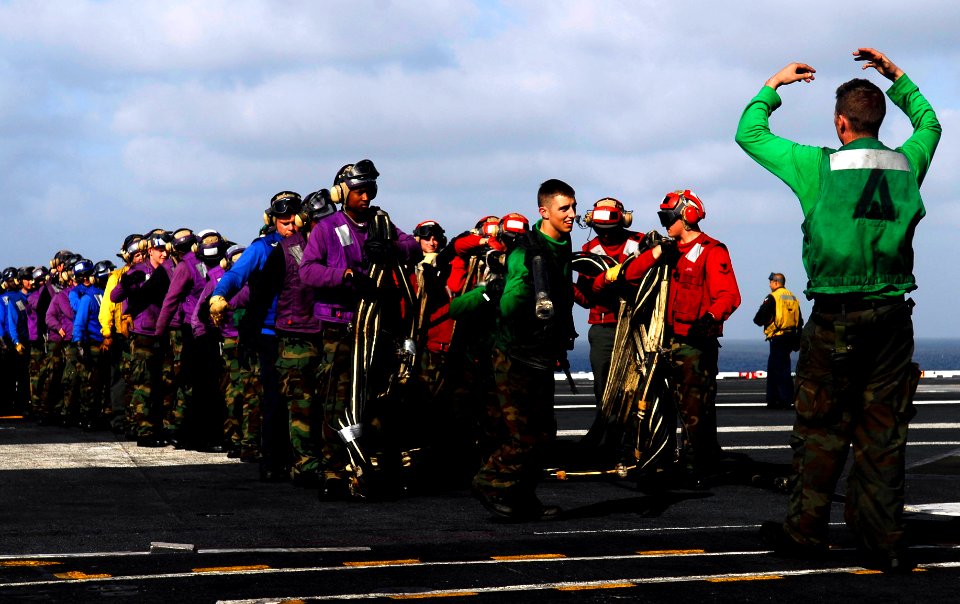 US Navy 081010-N-9928E-160 Aviation Boatswain's Mate (Equipment) 3rd Class Zach Bray directs flight deck personnel