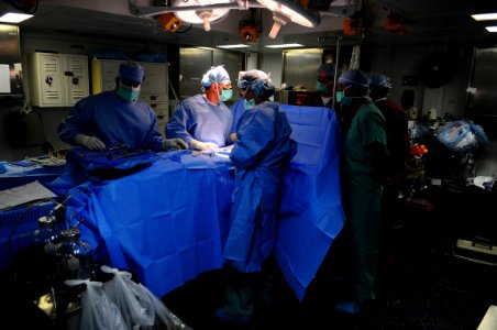 US Navy 081012-N-4515N-010 Eliecer Cruz Alvarez and Lt. Cmdr. Heliodoro Andres Salas Cablera conduct a cooperative surgery with medical personnel photo