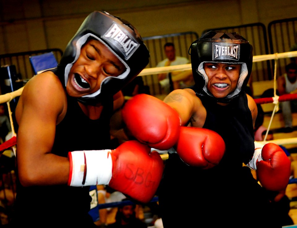 US Navy 081011-N-5345W-057 Cryptologic Technician Networks Seaman Janea Arrington connects with a straight right to the jaw of Aviation Ordnanceman Airman Nakita Boyd during a sparring session