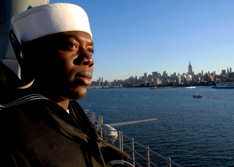 US Navy 081011-N-6439C-042 Ship's Serviceman 2nd Class Charles Agyeilarbi mans the rails aboard the amphibious assault ship USS Nassau (LHA 4) in New York for the Great White Fleet celebration