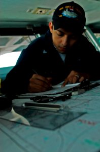 US Navy 081011-N-9928E-032 Quartermaster 3rd Class Rodolfo Espinoza makes a ship's positional fix entry while standing quartermaster of the watch