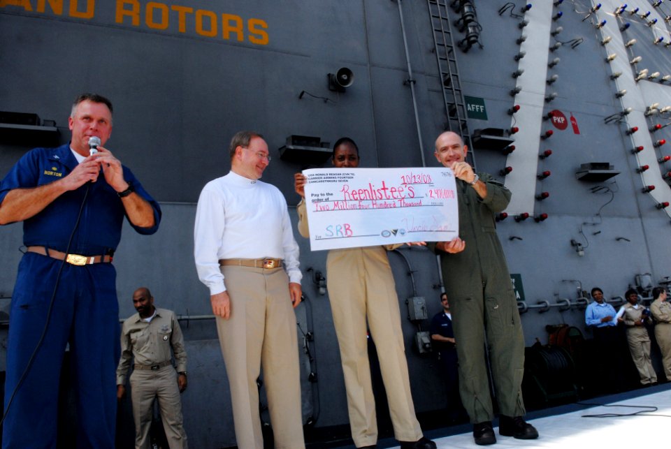 US Navy 081013-N-4005H-030 Capt. K.J. Norton, left, commanding officer of the Nimitz-class aircraft carrier USS Ronald Reagan (CVN 76), delivers remarks during a mass reenlistment ceremony aboard the Nimitz-class aircraft carri photo