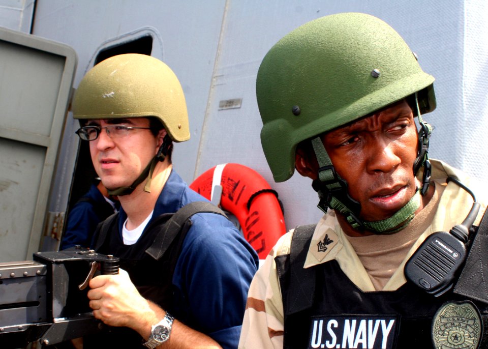 US Navy 081009-N-6764G-056 Electronics Technician 3rd Class Jefferey Maser and Master-at-Arms 1st Class Dwayne Doctor man a .50-caliber gun aboard the amphibious transport dock ship USS San Antonio (LPD 17)