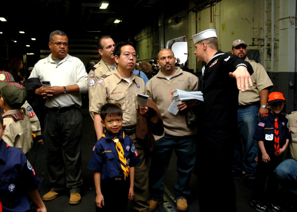 US Navy 081013-N-6439C-006 Aviation Boatswain's Mate Fuels 3rd Class Scott Jensen speaks with New York residents during a tour of the amphibious assault ship USS Nassau (LHA 4)