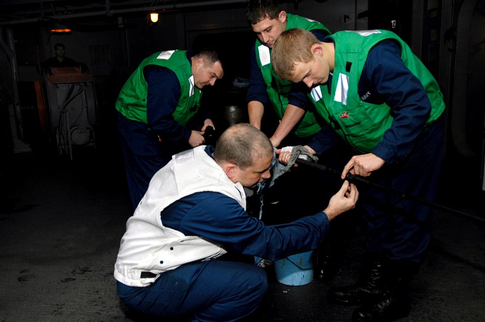 US Navy 081013-N-4954I-003 Chief Cryptologic Technician (Collection) Benjamin Meyer, left, from Fairfax, Va., and Cryptologic Technician (Technical) 3rd Class Josh Bundy, from Denver, inspect the Nixie torpedo countermeasure ca