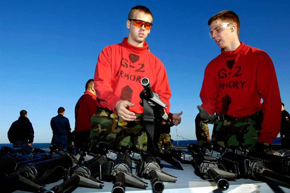 US Navy 081012-N-4954I-008 Gunner's Mate Seaman David Jones, left, from North Pole, Alaska and Aviation Ordnanceman Airman Cody Abadie, from Mccomb, Miss., assist other Sailors during M16A3 rifle certifications