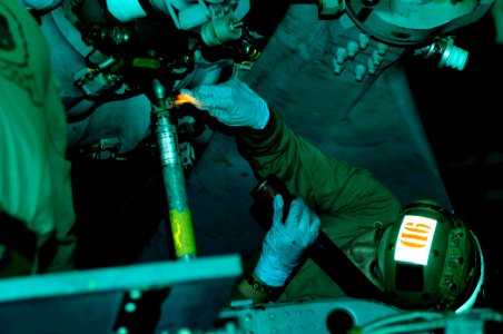 US Navy 081010-N-7918H-029 Aviation Structural Mechanic 2nd Class Edwin Ortiz conducts maintenance on a helicopter from Helicopter Antisubmarine Squadron (HS) 3 aboard the Nimitz-class aircraft carrier USS Theodore Roosevelt (C