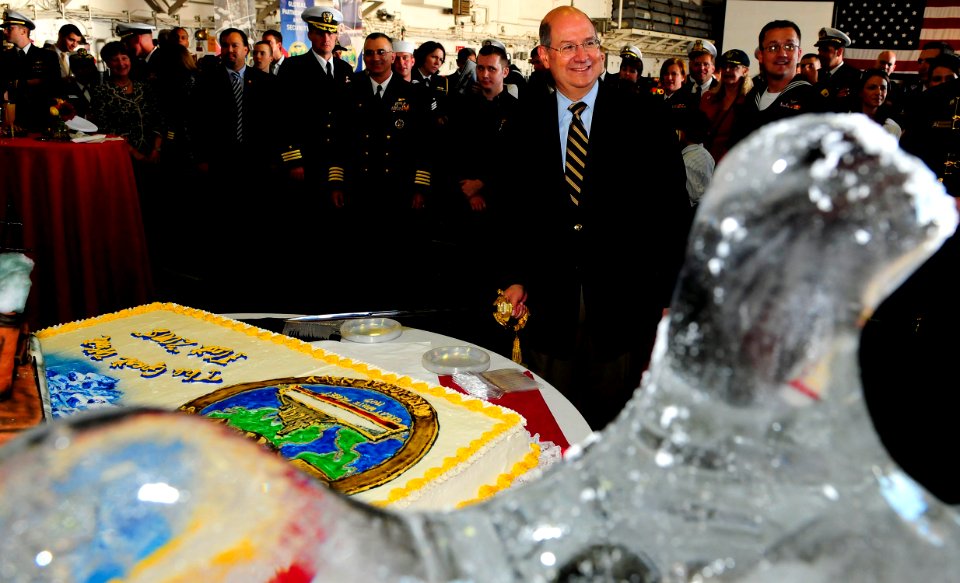 US Navy 081012-N-5758H-415 Secretary of the Navy (SECNAV) the Honorable Donald C. Winter cuts a cake cake during a commemoration ceremony celebrating the 100th anniversary of the Great White Fleet
