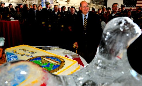 US Navy 081012-N-5758H-415 Secretary of the Navy (SECNAV) the Honorable Donald C. Winter cuts a cake cake during a commemoration ceremony celebrating the 100th anniversary of the Great White Fleet