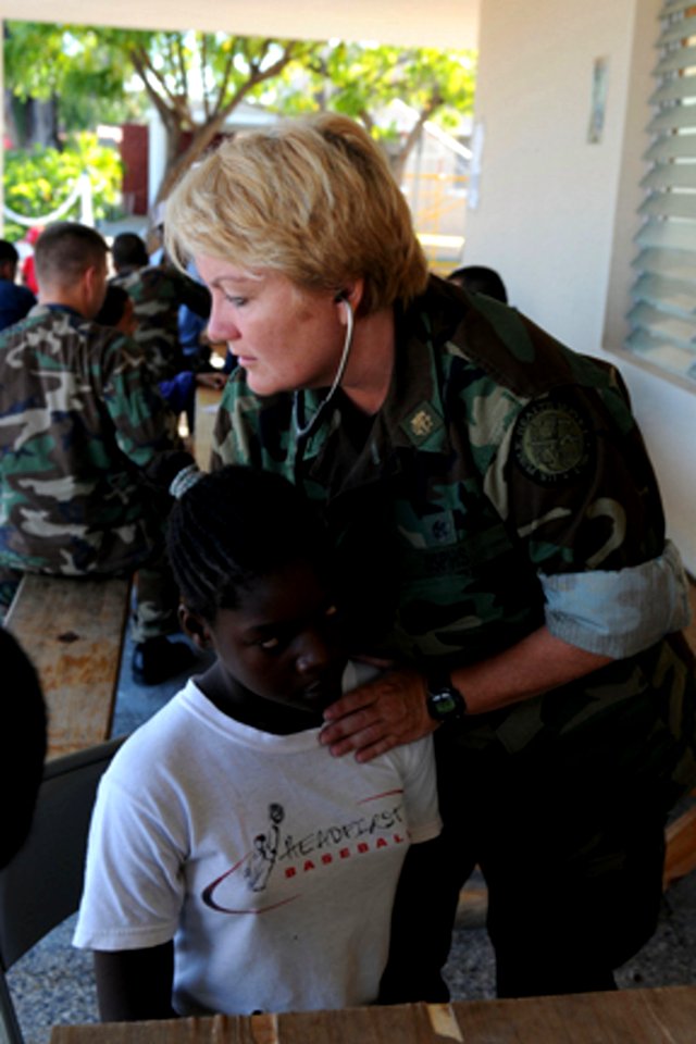 US Navy 081010-N-7955L-018 Cmdr. Lisa Hogan examines a child