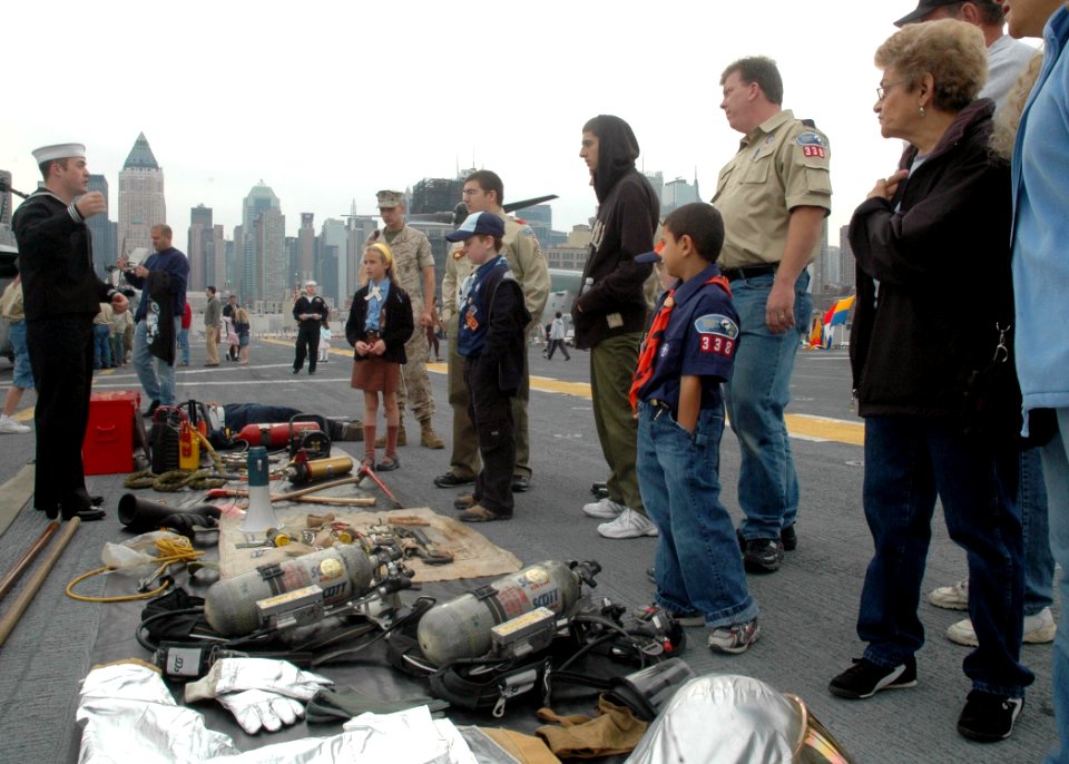 US Navy 081013-N-6439C-022 Aviation Boatswain's Mate Handler 3rd Class Paul Bria speaks with New York residents during a tour of the amphibious assault ship USS Nassau (LHA 4)