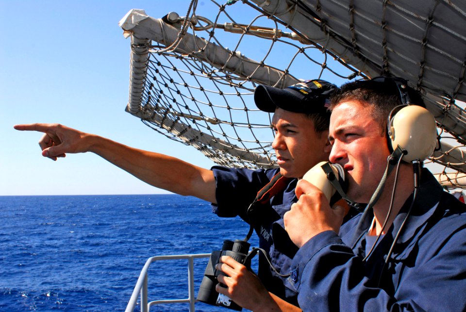 US Navy 081012-N-9610C-009 Seaman Jeff Raynor, from Alvin, Texas, and Boatswain's Mate Seaman Apprentice Nick Meyers, from Laguna Niguel, Calif., relay surface contact information over a sound-powered telephone