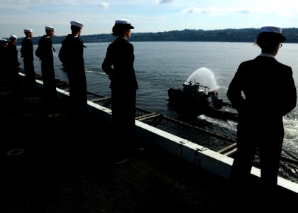 US Navy 081012-N-9898L-015 Sailors man the rails as the aircraft carrier USS Abraham Lincoln (CVN 72) returns to its homeport of Everett photo