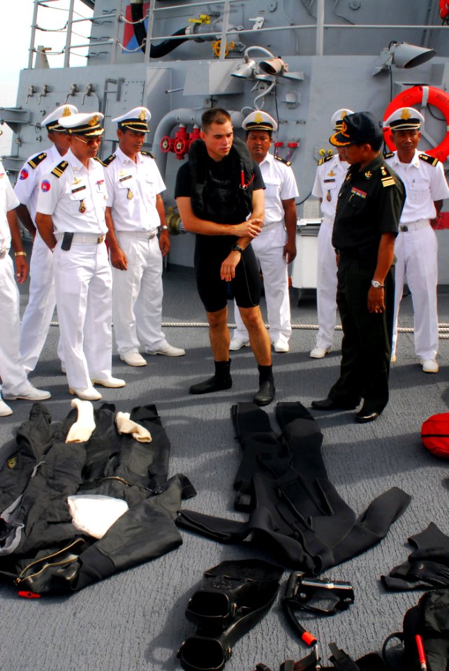 US Navy 081014-N-2013O-001 Gunner's Mate 2nd Class Joshua Flamand talks about the equipment used by search and rescue swimmers with sailors from the Royal Cambodian navy