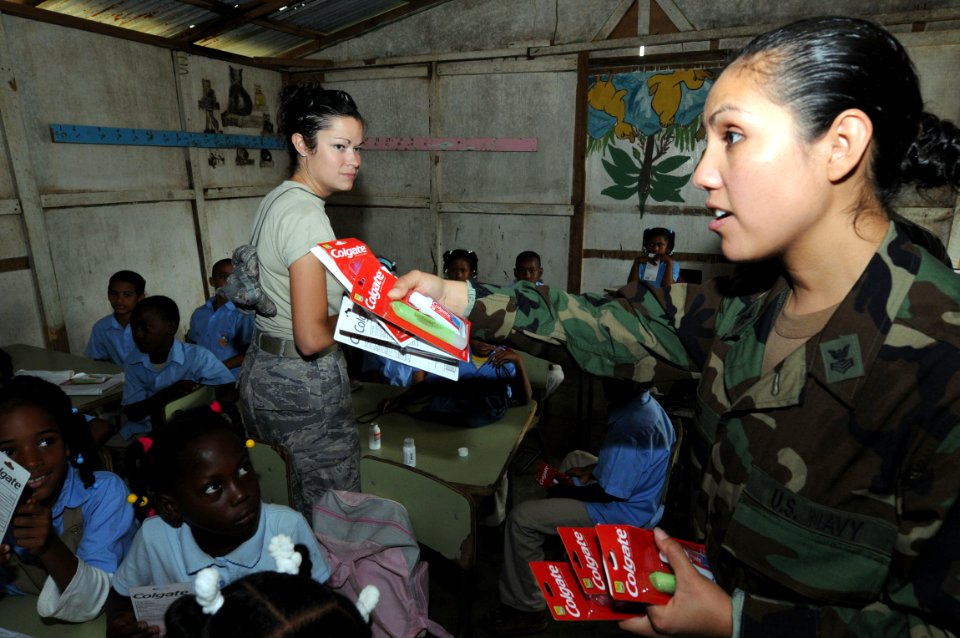 US Navy 081013-N-9774H-031 Aerographer's Mate 1st Class Maria Alfaro, assigned to Strike Group Oceanography Team, Norfolk, VA. embarked aboard the amphibious assault ship USS Kearsarge (LHD 3), hands out toothbrush and toothpas