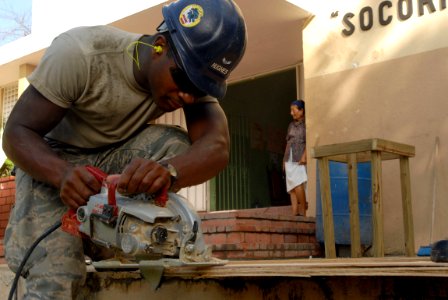 US Navy 081013-N-3595W-046 Airman 1st Class Pasha Hughes, embarked aboard the amphibious assault ship USS Kearsarge (LHD 3), helps repair a neighborhood school during a Continuing Promise 2008 humanitarian assistance project photo