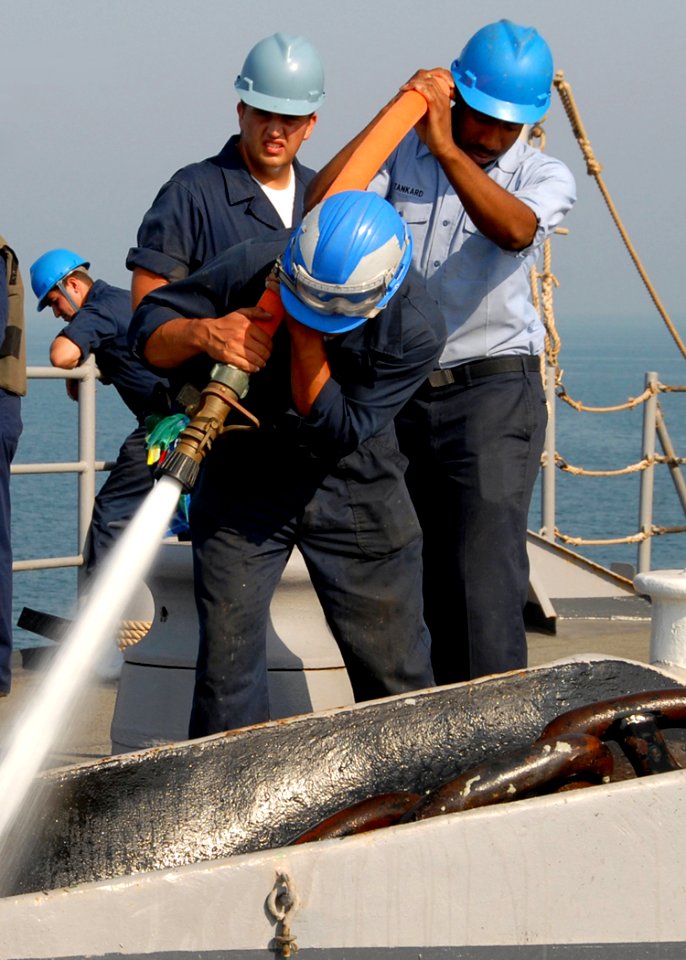 US Navy 081013-N-9134V-049 Sailors from sea and anchor detail hose down the anchor chain aboard the amphibious dock landing ship USS Carter Hall (LSD 50)