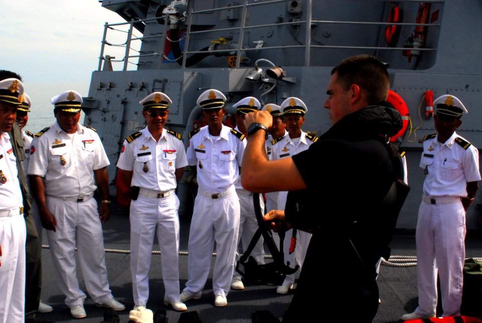 US Navy 081014-N-2013O-002 Gunner's Mate 2nd Class Joshua Flamand talks about the equipment used by search and rescue swimmers with sailors from the Royal Cambodian navy