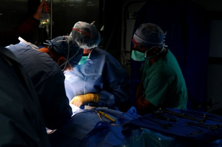 US Navy 081012-N-4515N-028 Eliecer Cruz Alvarez watches Dr. Sharon Weintraub perform a hernia operation