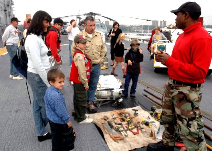US Navy 081013-N-6439C-038 Aviation Boatswain's Mate (Handling) 3rd Class Mazi Nickelson talks with New York residents during a tour of the amphibious assault ship USS Nassau (LHA 4)