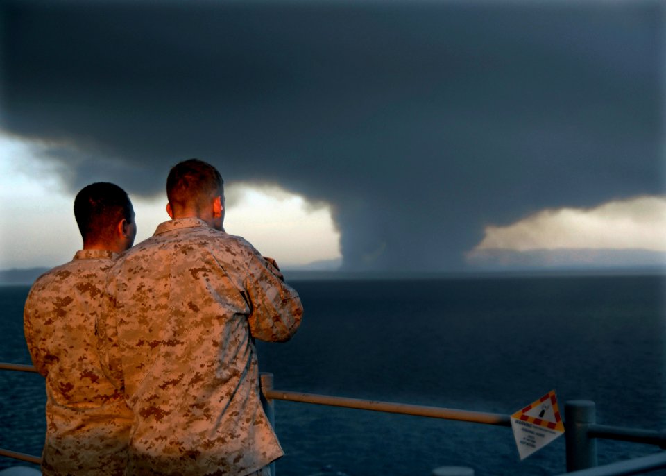 US Navy 081013-N-9150R-003 Marines assigned to the 13th Marine Expeditionary Unit (13 MEU) watch from the observation deck of the amphibious assault ship USS Boxer (LHD 4) as smoke rises from a wildfire near Marine Corps Base C