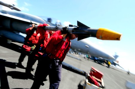 US Navy 081014-N-7918H-180 Aviation Ordnancemen assigned to VFA-15 detach a missile from an aircraft aboard the aircraft carrier USS Theodore Roosevelt (CVN 71)
