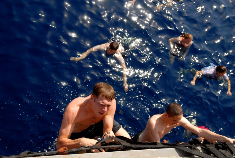 US Navy 081016-N-1635S-005 Sailors climb aboard the Ticonderoga-class guided-missile cruiser USS Chancellorsville (CG 62) during a scheduled swim call