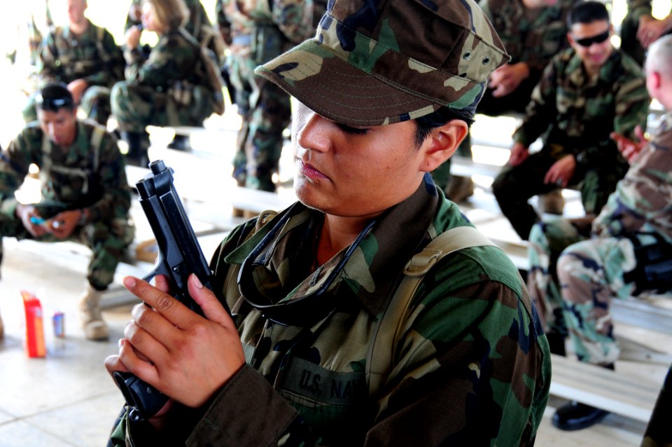 US Navy 081014-N-0411D-014 U.S. Navy Equipment Operator Christina Chingman practices breaking down her Beretta M9 pistol during a handgun marksmanship course at Expeditionary Combat Skills School