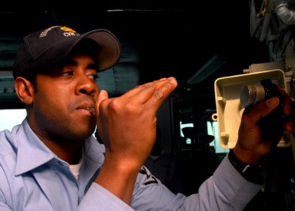 US Navy 081015-N-2456S-058 Boatswain's Mate 3rd Class Richard Nelson pipes the boatswain's pipe on the 1MC aboard the aircraft carrier USS Theodore Roosevelt (CVN 71)