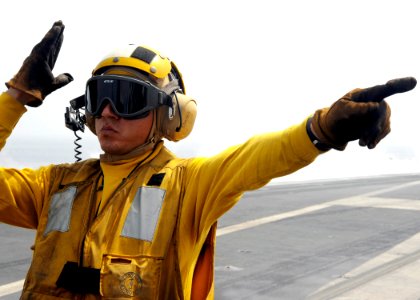 US Navy 081016-N-7571S-007 Aviation Boatswain's Mate 3rd Class Stephen Vaiza directs an aircraft during flight operations aboard the aircraft carrier USS Theodore Roosevelt (CVN 71)