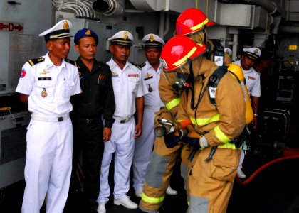 US Navy 081014-N-2013O-005 Sailors demonstrate proper hose handling technique to sailors from the Royal Cambodian navy photo