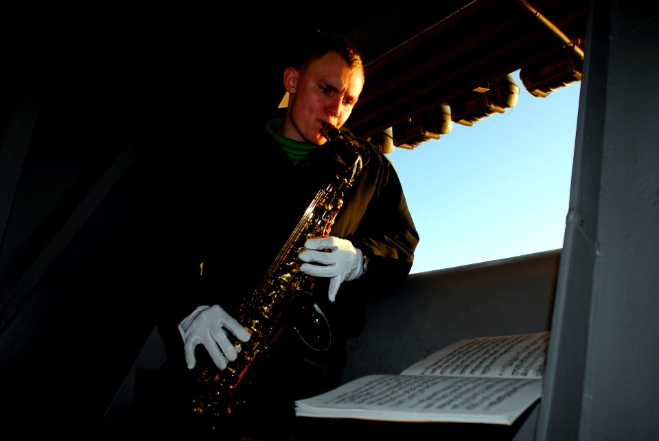 US Navy 081012-N-9610C-013 Aviation Electronics Technician 2nd Class Jonathan Edwards of Houston, Texas, plays saxophone during his off time on the starboard side work-out sponson aboard the Nimitz-class aircraft carrier USS Jo