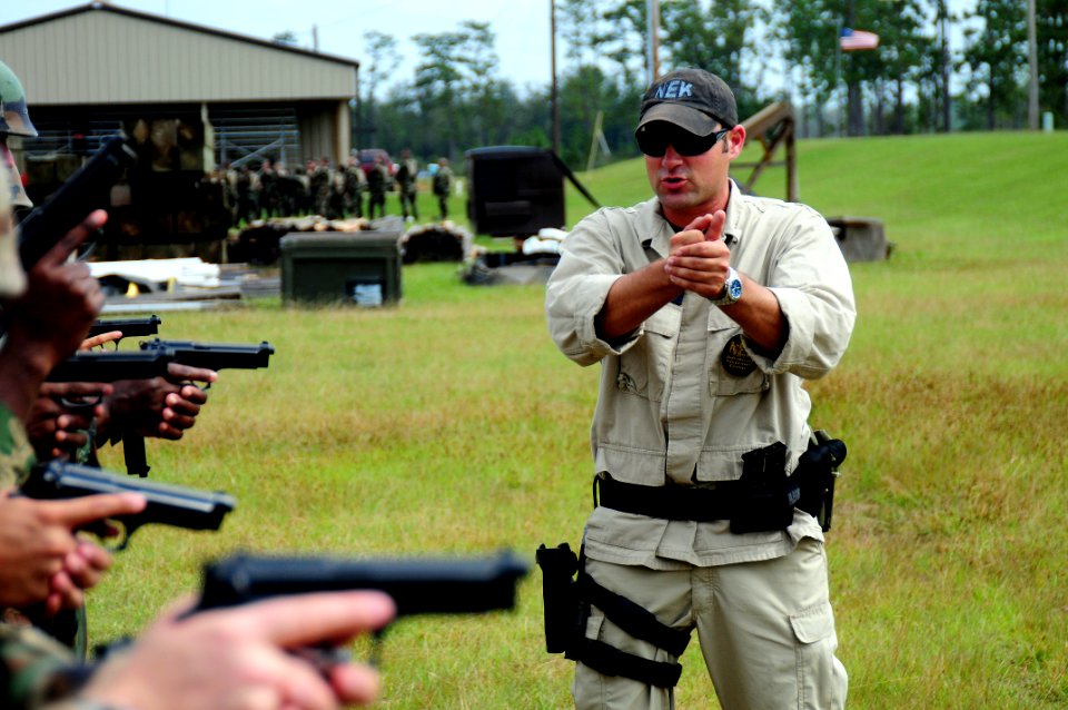US Navy 081014-N-0411D-022 Former U.S. Army tanker Emmett Lawrence trains U.S. Navy sailors in handgun marksmanship at Woolmarket Pistol and Rifle Range