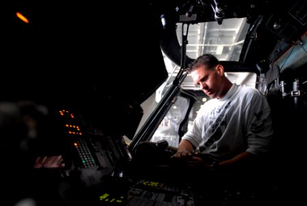 US Navy 081016-N-3610L-037 Aviation Electrician's Mate 1st Class Ryan Lontos checks the stabilizing systems in the cockpit of an SH-60F Seahawk helicopter assigned to the