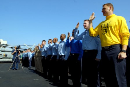 US Navy 081013-N-4005H-022 Sailors recite the oath of enlistment during a mass reenlistment ceremony for 117 Sailors aboard the Nimitz-class aircraft carrier USS Ronald Reagan (CVN 76) photo