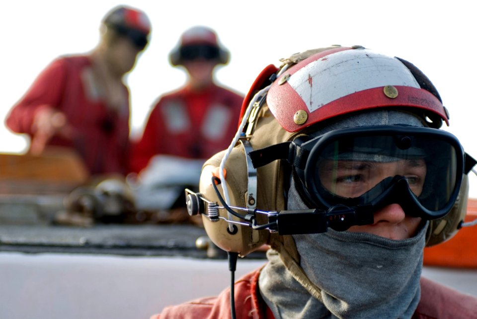 US Navy 081015-N-5253W-007 Aviation Boatswain's Mate (Handling) Matthew Small, from Piggott, Ark. assigned to the forward-deployed amphibious assault ship USS Essex (LHD 2), looks out across the ship's flight deck