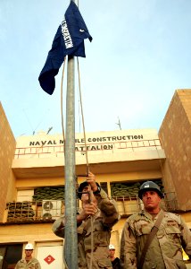 US Navy 081016-N-1120L-138 eabees assigned to Naval Mobile Construction Battalion (NMCB) 7 raise the battalion colors during a Transfer of Authority ceremony