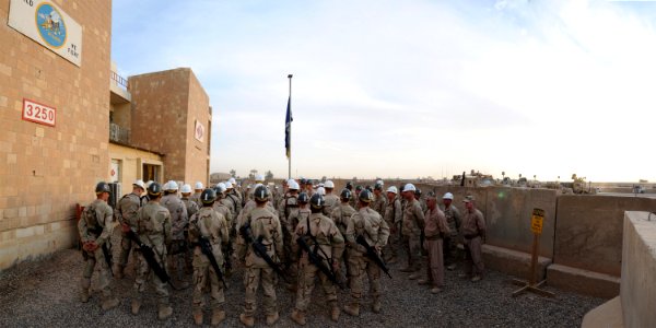 US Navy 081016-N-1120L-500 Seabees assigned to Naval Mobile Construction Battalion (NMCB) 7 and NMCB-3 stand at ease during speeches at a Transfer of Authority ceremony