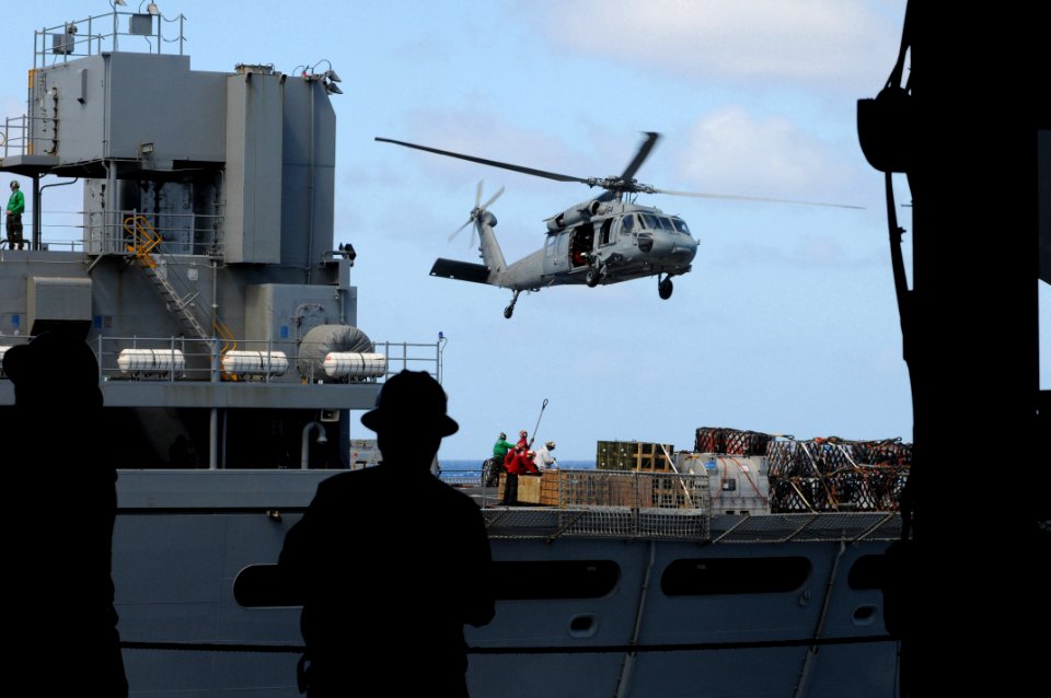 US Navy 090605-N-4995K-044 Sailors aboard the aircraft carrier USS Ronald Reagan (CVN 76) watch through hangar bay