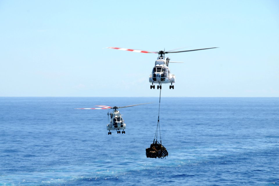 US Navy 081019-N-0120A-145 Two EH-96 Puma helicopters from the Military Sealift Command dry cargo ship USNS Richard E. Byrd (T-AKE-4) take turns delivering supplies