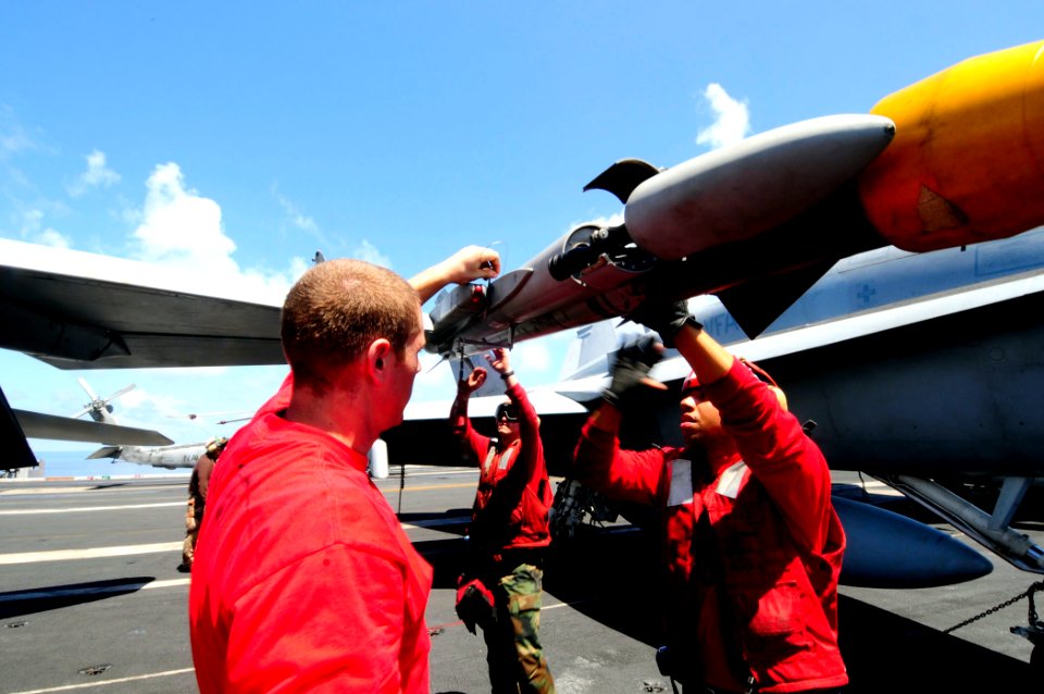 US Navy 081014-N-7918H-168 Aviation Ordnancemen prepare to attach missiles to an aircraft